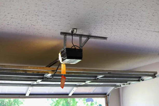Garage door opener motor mounted on a garage ceiling