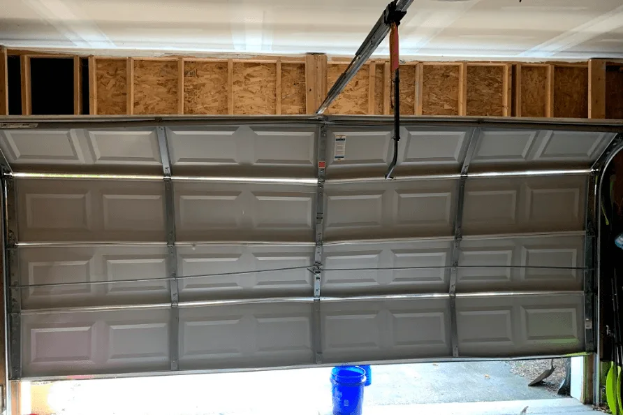 Technician's view of a garage door being repaired from inside a Mobile garage